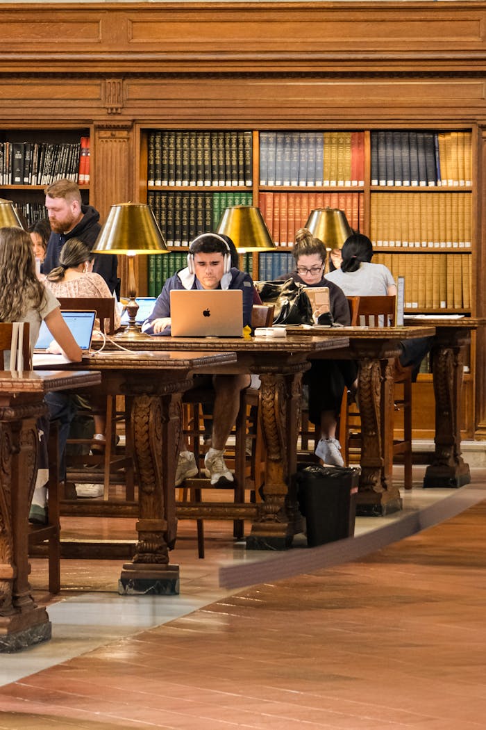 People focused on studying inside the New York Public Library, showcasing an academic atmosphere.